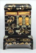 A late 19th/early 20th century Japanese shibyama inlaid lacquered table cabinet The hinged top
