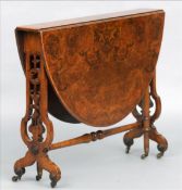 A Victorian burr walnut Sutherland table The twin flap oval top supported on pierced trestle end