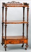 A Victorian burr walnut whatnot The three quarter fret work galleried top supported on turned