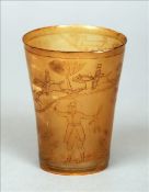 A carved horn beaker Decorated with a hunting scene. 11 cms high. Some slight fritting, chipping and