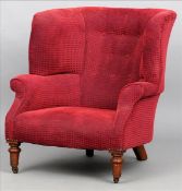 A Victorian upholstered tub armchair The buttoned back above the overstuffed seat, standing on