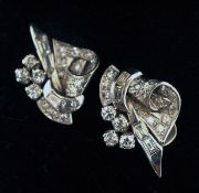 A pair of Art Deco style unmarked white gold or platinum diamond set clip on earrings Of ornate