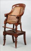An early 19th century caned mahogany child`s high chair The curved top rail above the caned back and