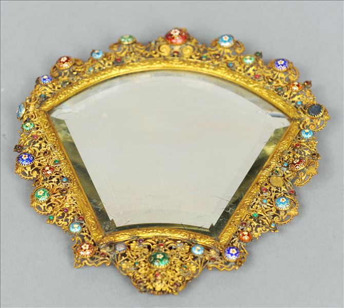 A 19th century enamel and semi-precious stone mounted gilt metal filigree mirror The ornate frame