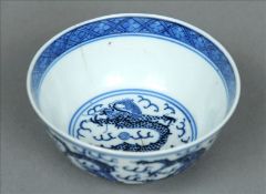 A Chinese blue and white porcelain bowl Extensively decorated with dragons chasing flaming pearls