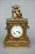 An ormolu mounted bronze mantel clock The top surmounted with a cherub above the main body with twin