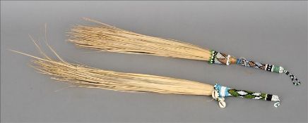 Two early 20th century Papuan beaded dried grass/split leaf beaded whisks Both typically