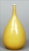 A Chinese porcelain bottle vase Of tear form, with tall slender neck, allover ochre glazed. 22 cms