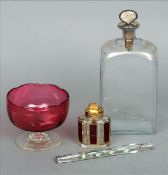 A gilt decorated clear glass decanter, a cranberry glass footed bowl, a gilt decorated Bohemian