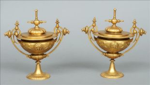 A pair of 19th century ormolu urns and covers Each removable lid flanked by lion mask mounted