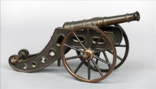 A 19th century lacquered bronze model canon Modelled with various moving and adjustable parts. 31.