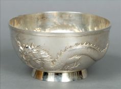 A Chinese silver bowl Decorated to the outer rim with a dragon, standing on a spreading foot, the