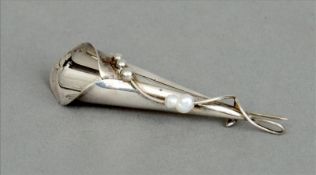 A white metal posy holder brooch Organically modelled mounted with seed pearls. 7.5 cms long.
