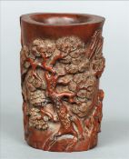A late 19th/early 20th century Chinese carved wooden brush pot Of cylindrical form, carved with