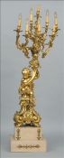 A large 19th century Continental ormolu eight branch candelabra Formed as a putti sitting on a