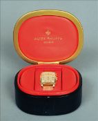 An 18 ct gold cased Patek Philippe gentleman`s wristwatch The square dial with Roman numerals and