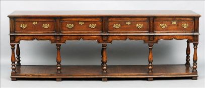 An 18th century style oak low dresser The moulded rectangular top above four frieze drawers with