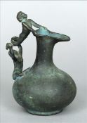 A Roman style patinated bronze ewer Of typical bulbous form, the handle modelled as two acrobatic