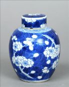 A Chinese blue and white porcelain ginger jar and cover Decorated with blossom sprays on a blue