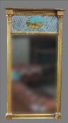A 19th century gilt framed pier glass The beaded cornice above a reverse painted panel depicting the