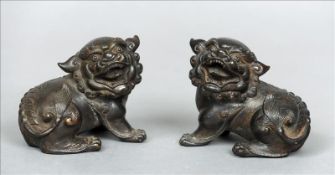 A well modelled pair of 18th century Chinese bronze dogs-of-fo Each modelled on all fours. 10 cms