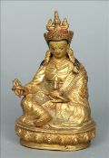 A 19th century Sino-Tibetan gilt bronze model of Buddha Seated in the lotus position holding a Vajra