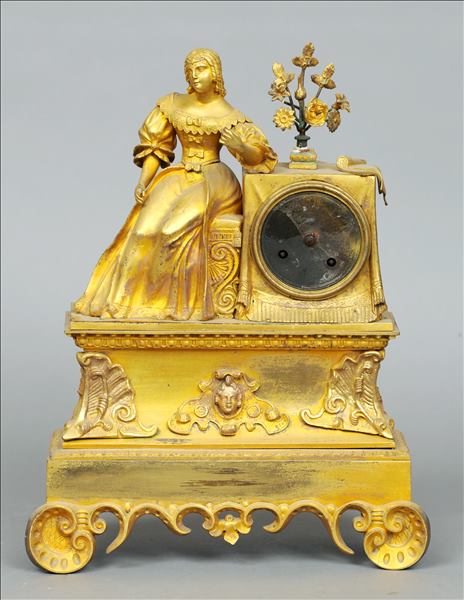 A 19th century ormolu mantle clock Surmounted with a young lady beside a bouquet of flowers above