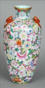 A Chinese porcelain vase With applied bat handles and extensively decorated with flowerheads, red