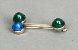 A white metal lapis lazuli and green jade set brooch Of modernist design. 4.5 cms long. Generally in