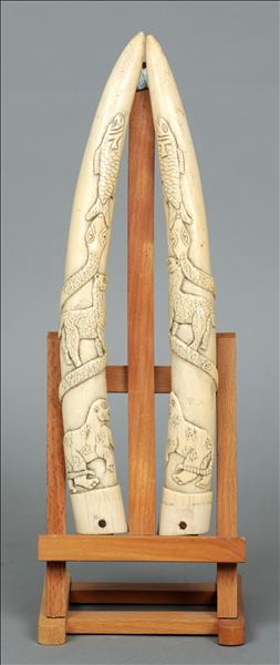 A pair of 19th century ivory tusk carvings Carved in the round with various animals, including a