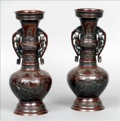 A pair of late 19th/early 20th century Japanese patinated bronze vases Each with a flared rim