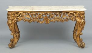 A 19th century carved giltwood console table The marble mounted serpentine top above a foliate and