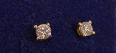 A pair of diamond solitaire ear studs Each stone approximately 0.25 carat.