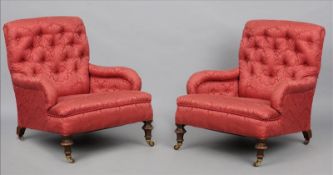 A pair of Victorian Howard style upholstered armchairs The button backs above the low sweeping