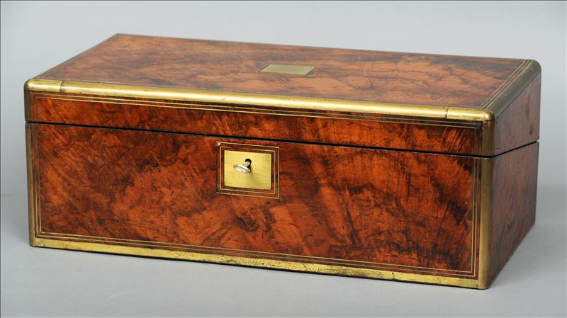 A Victorian brass bound walnut writing slope The hinged rectangular top with a central vacant