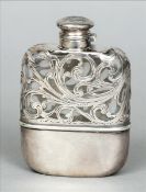 An Art Nouveau silver overlay clear glass hip flask The initialled hinged lid above a section of