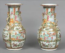 A pair of 19th century Cantonese famille rose vases Each flared neck rim above twin gilded dragon