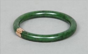 A 19th century Chinese rich spinach green jade and unmarked gold bangle Together with a pair of 18