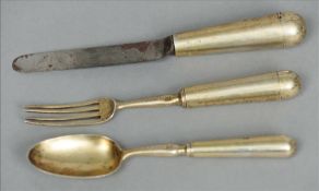 A Victorian suite of three pieces of silver gilt campaign cutlery, the fork and spoon blades