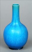 A Chinese porcelain bottle vase Blue glazed with incised lotus strapwork decoration. 16 cms high.