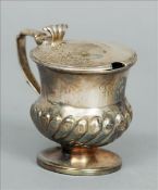 Two George III silver mustard pots, each hallmarked London, date letters rubbed, one with maker`s