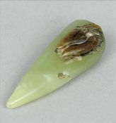 A Chinese carved green and russet jade group Modelled as a vegetable. 7.5 cms long. Generally in