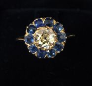 An 18 ct gold "Champagne" diamond and sapphire target set ring The central stone spreading to