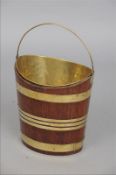 A 19th century brass bound mahogany bucket Of navette form with brass swing loop handle and brass