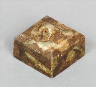 A Chinese carved mottled green jade seal Of square section, the matrix with archaistic script,