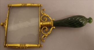 A 19th century Continental gilt metal mounted eye glass With ribbon carved spinach jade baluster