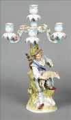 A Continental porcelain candelabrum Of scrolling floral form, standing on a domed spreading base