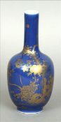 A Chinese porcelain bottle vase Gilt decorated with an exotic bird within floral sprays issuing from
