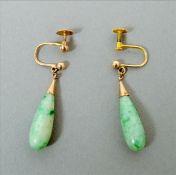 A pair of 9 ct gold mounted jade earrings Each of drop form with a screw-in clasp, the drops 2.5 cms