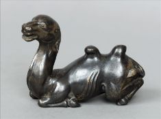 An 18th century Chinese model of a Bactrian camel Modelled in recumbent position. 13 cms wide.
